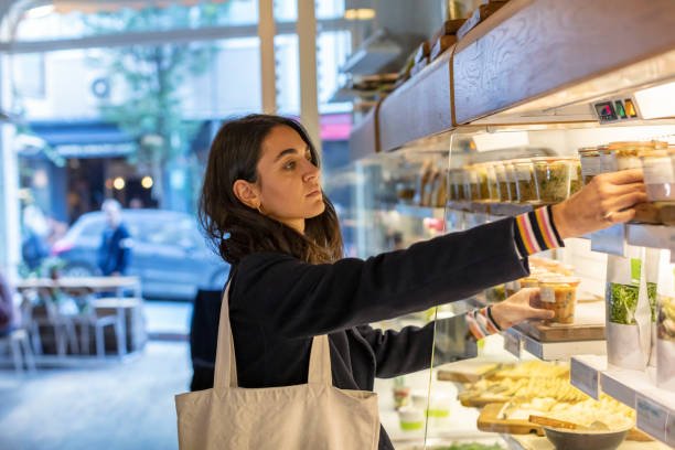 young woman customer looking for organic food in bio food store