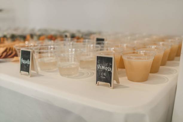 drinks with chalk signs at an event. brunch with mimosas and fruit snacks